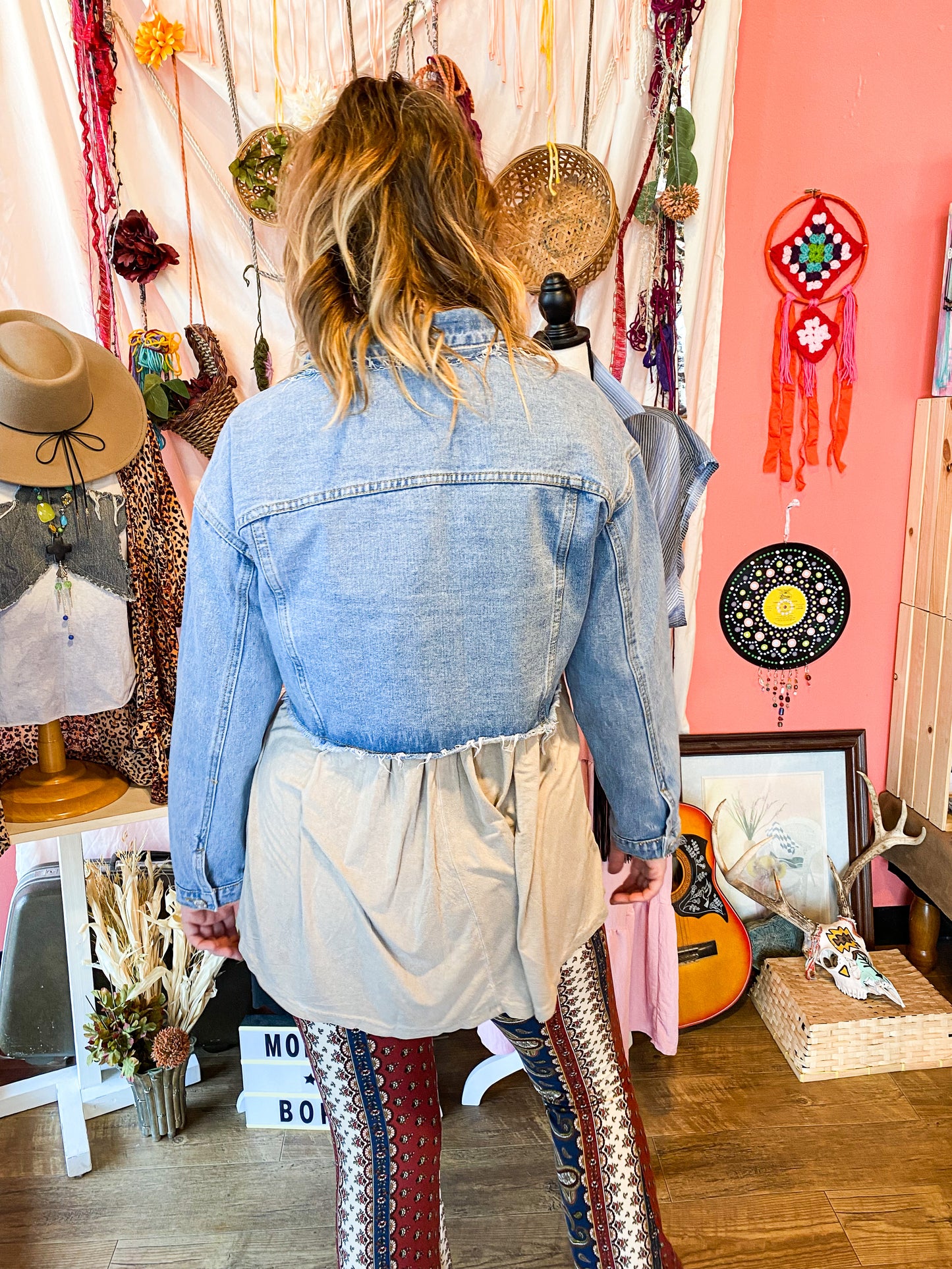 Light wash cropped and distressed denim jacket