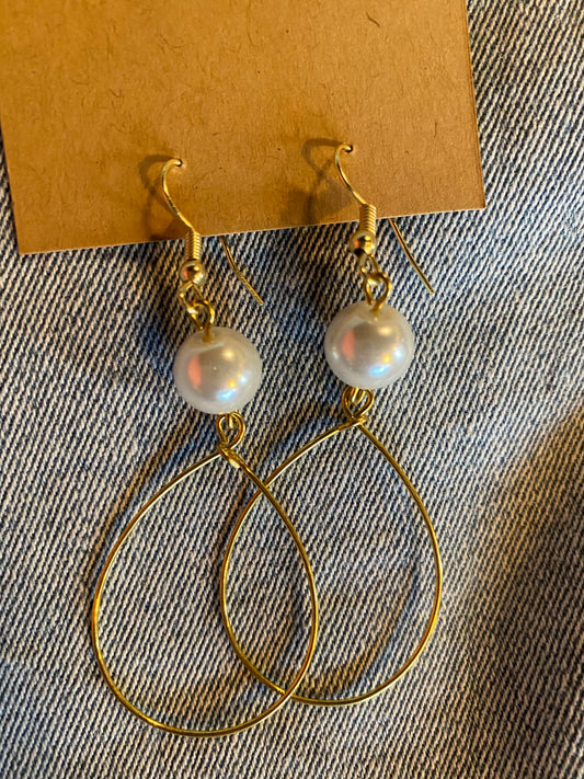 large pearl on top of wire hoop earrings