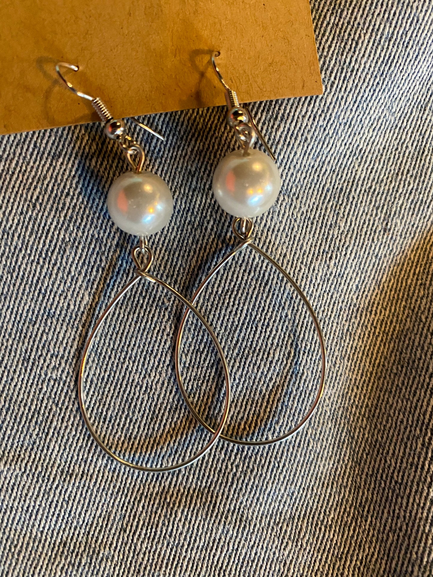 large pearl on top of wire hoop earrings