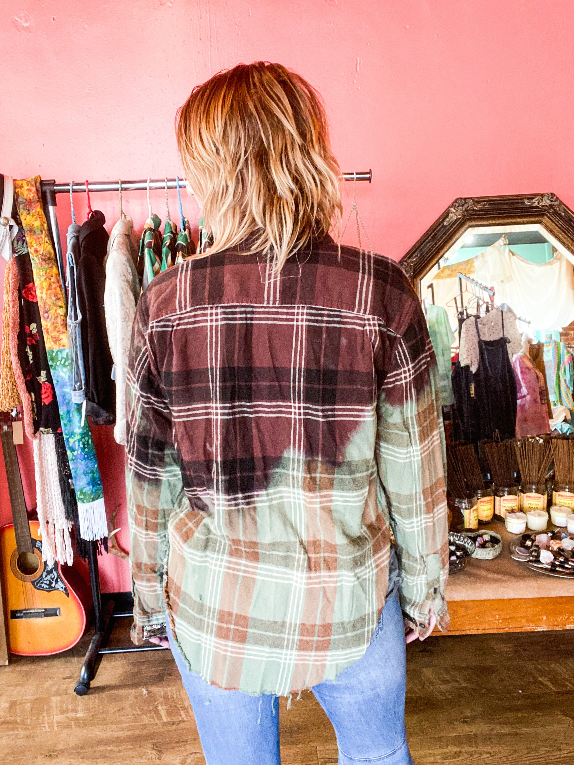 back view of Green and maroon brown bleached and distressed cropped hi low hem flannel featuring vintage buttons and detailed ribbon